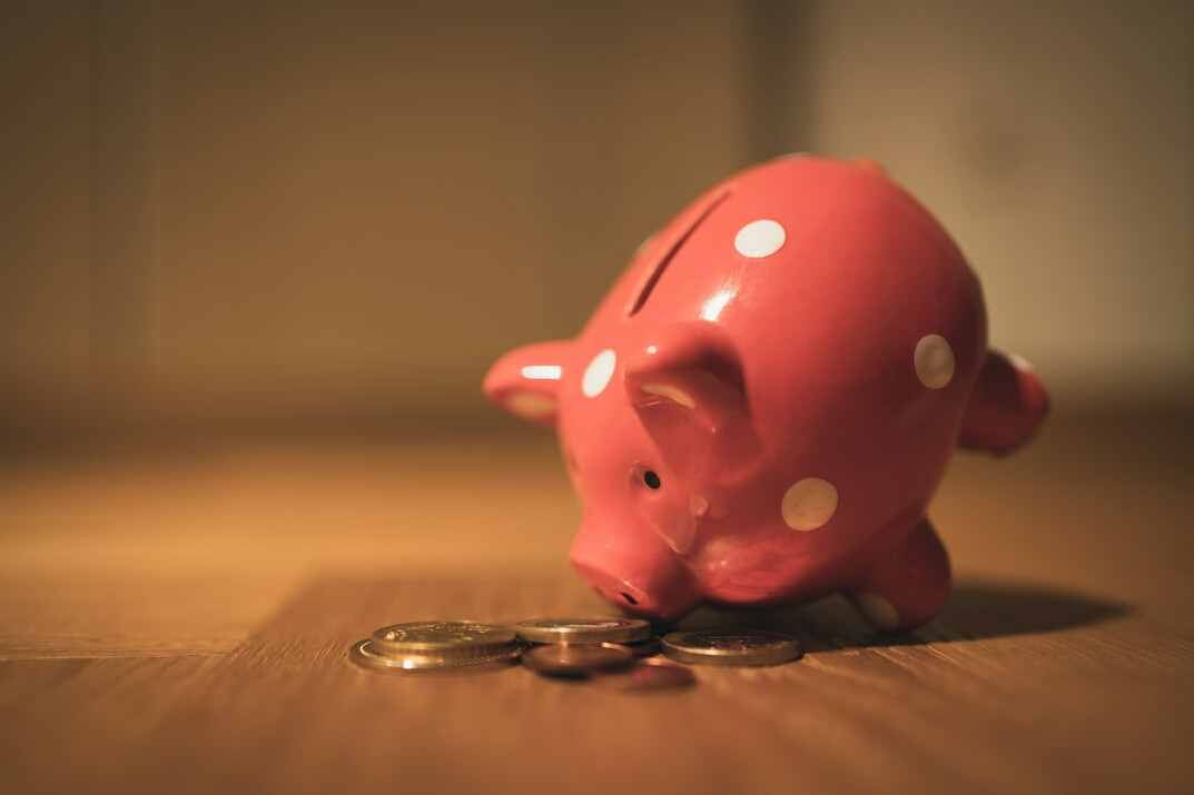 person saving money in piggy bank