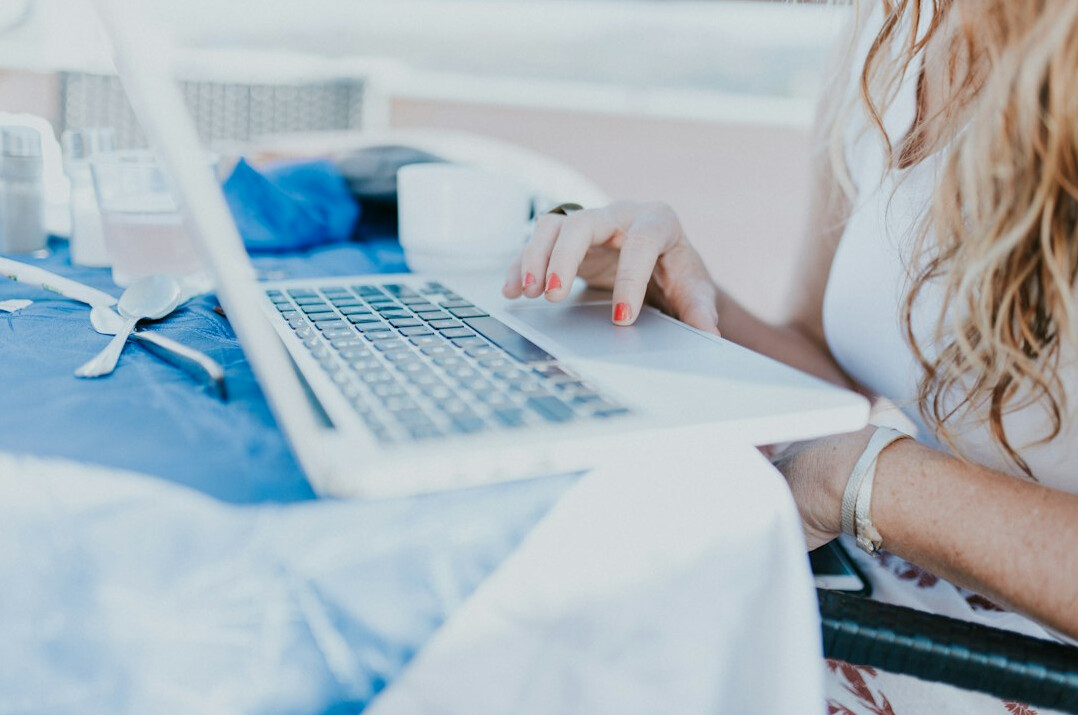woman tracking expenses on laptop