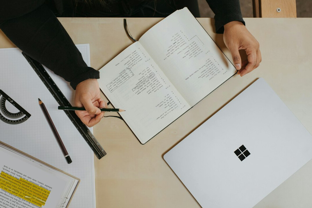 person budgeting with notebook